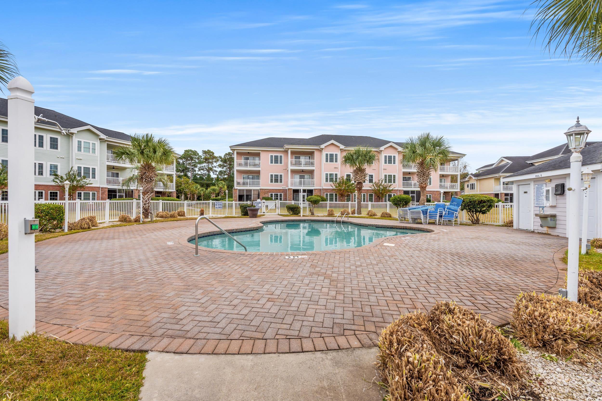 4864 Carnation Circle, Unit 304 Myrtle Beach, SC 29577 - Photo 26 of 36 Community pool with a patio area