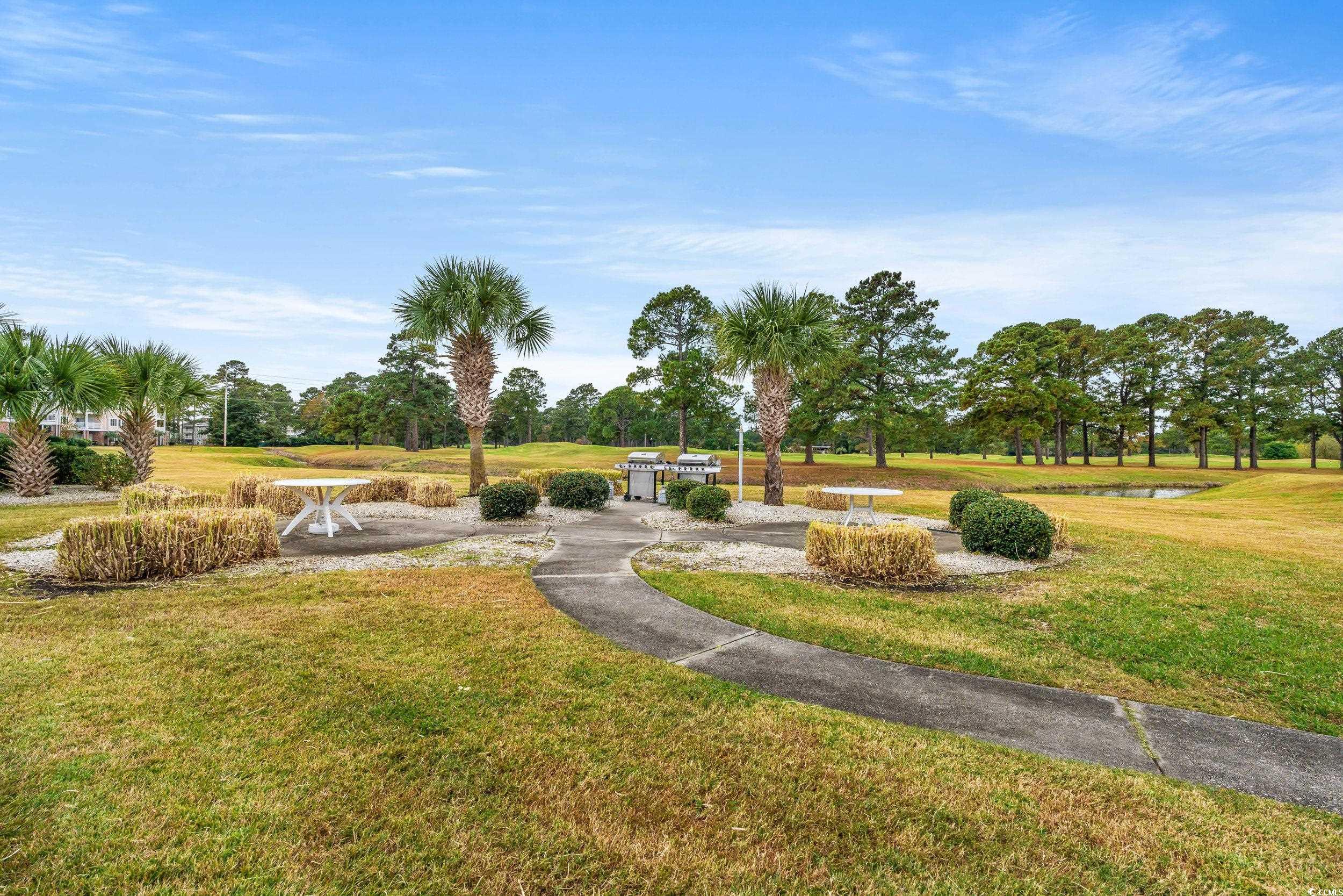 4864 Carnation Circle, Unit 304 Myrtle Beach, SC 29577 - Photo 32 of 36 Surrounding community featuring a yard and a water view