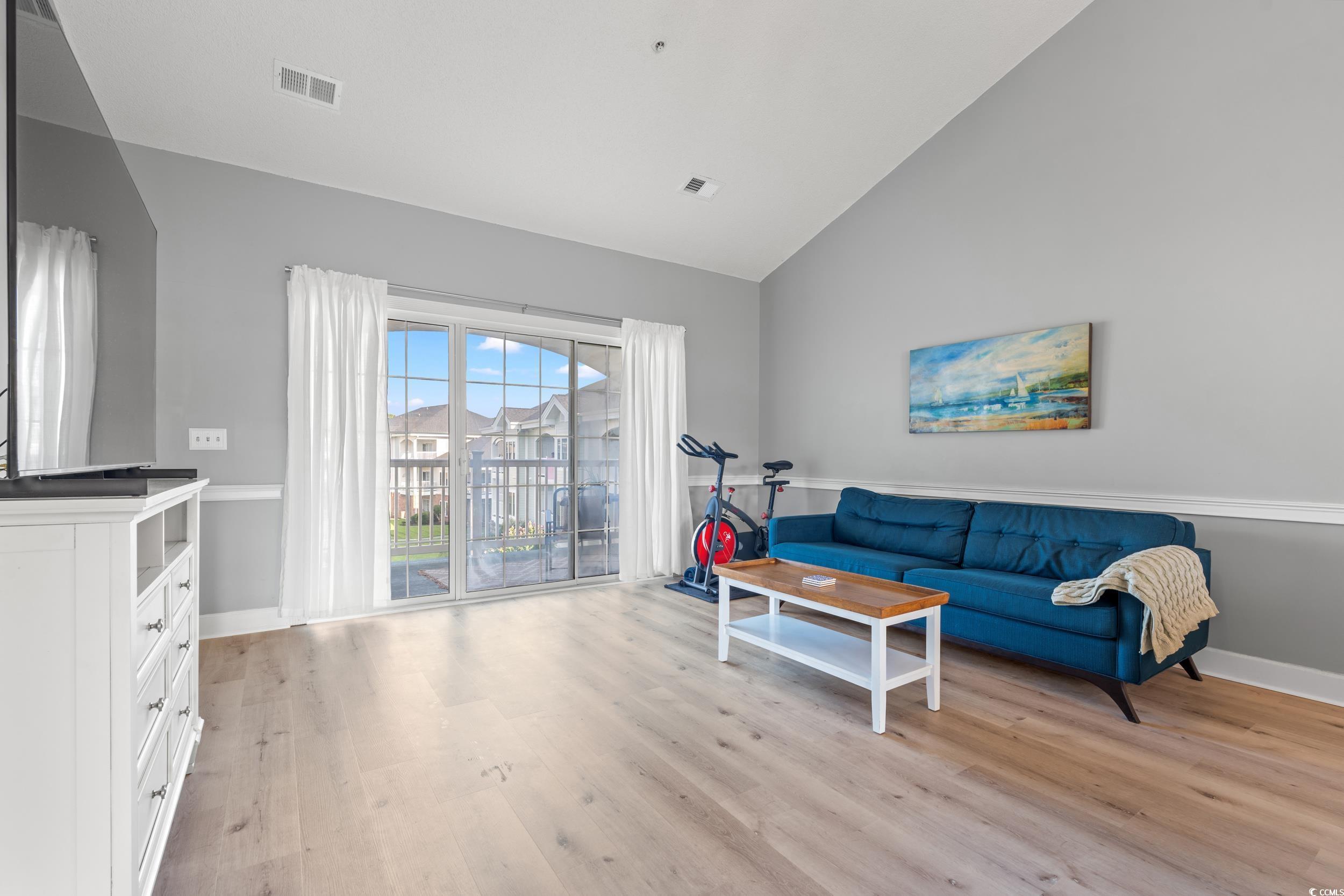 4864 Carnation Circle, Unit 304 Myrtle Beach, SC 29577 - Photo 5 of 36 Living room featuring high vaulted ceiling and light wood-style flooring