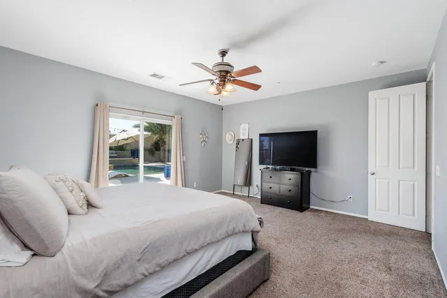 a bathroom with a granite countertop double vanity sink shower and a mirror