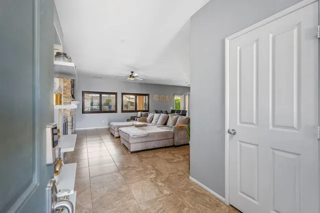 a living room with furniture and kitchen view