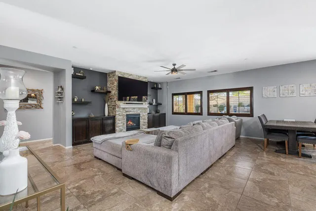 a living room with a fireplace furniture and a flat screen tv