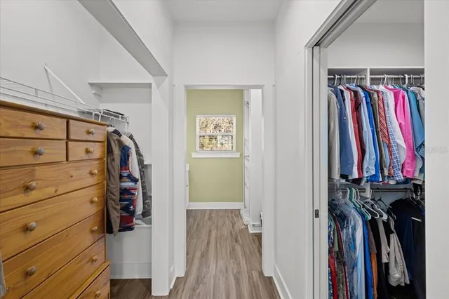 a view of walk in closet with clothes