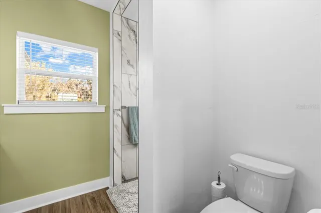 a bathroom with a toilet and a shower