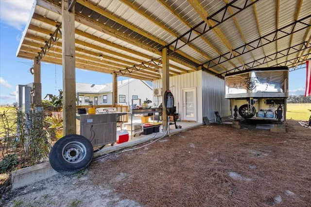 a view of a house with a backyard porch and sitting area