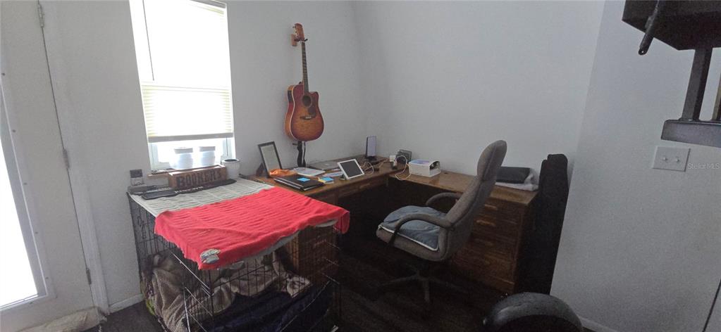 206 Lake Ida Road Frostproof, FL 33843 - Photo 17 of 46 a living room with furniture and a window