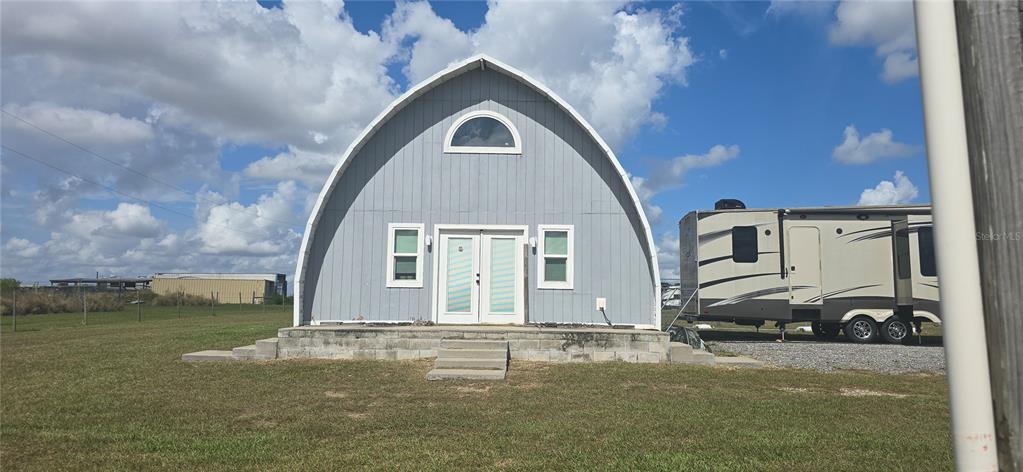 206 Lake Ida Road Frostproof, FL 33843 - Photo 9 of 46 a front view of a house with garden