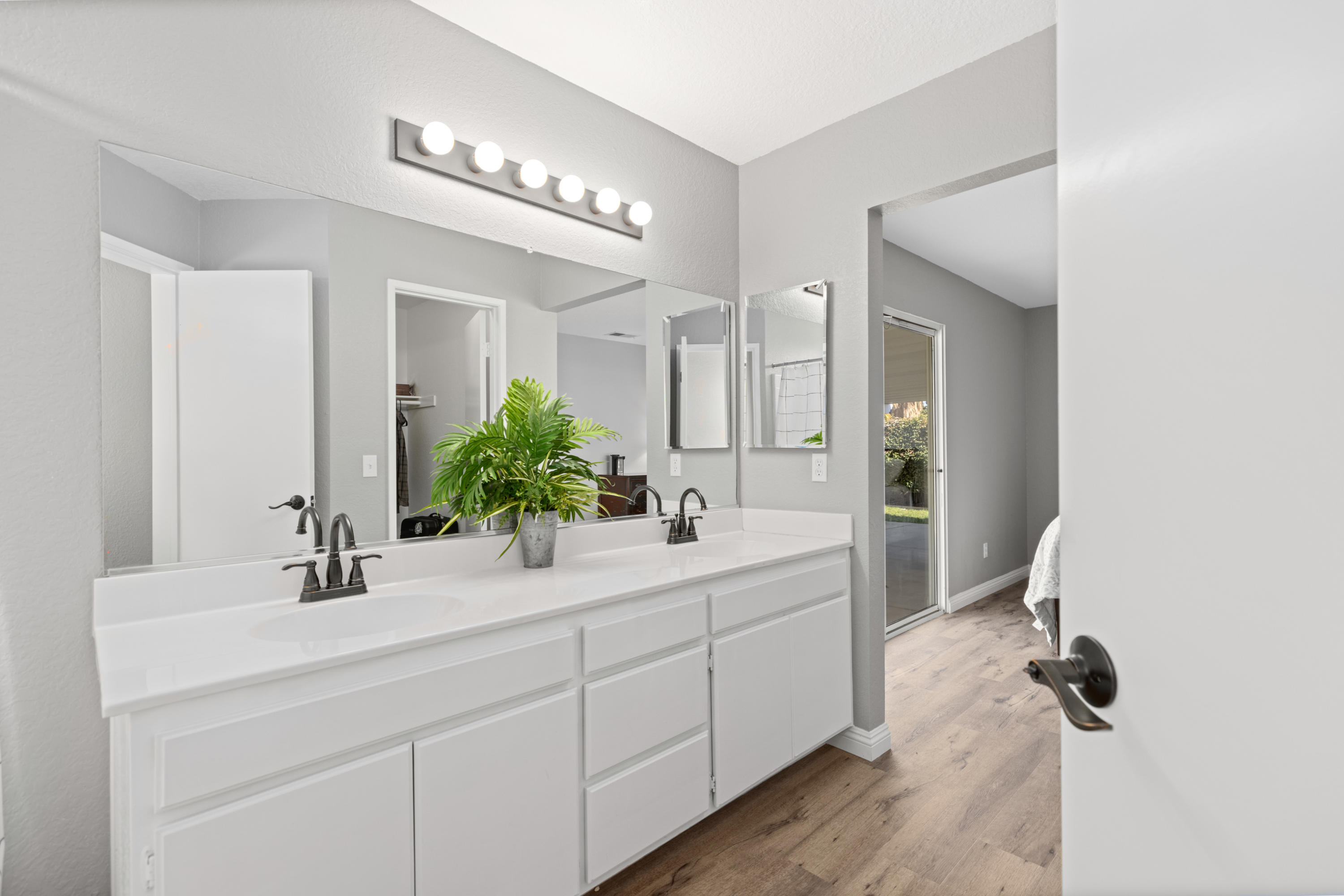 40325 Argyle Lane Palmdale, CA 93551 - Photo 13 of 24 a bathroom with a double vanity sink a mirror and shower
