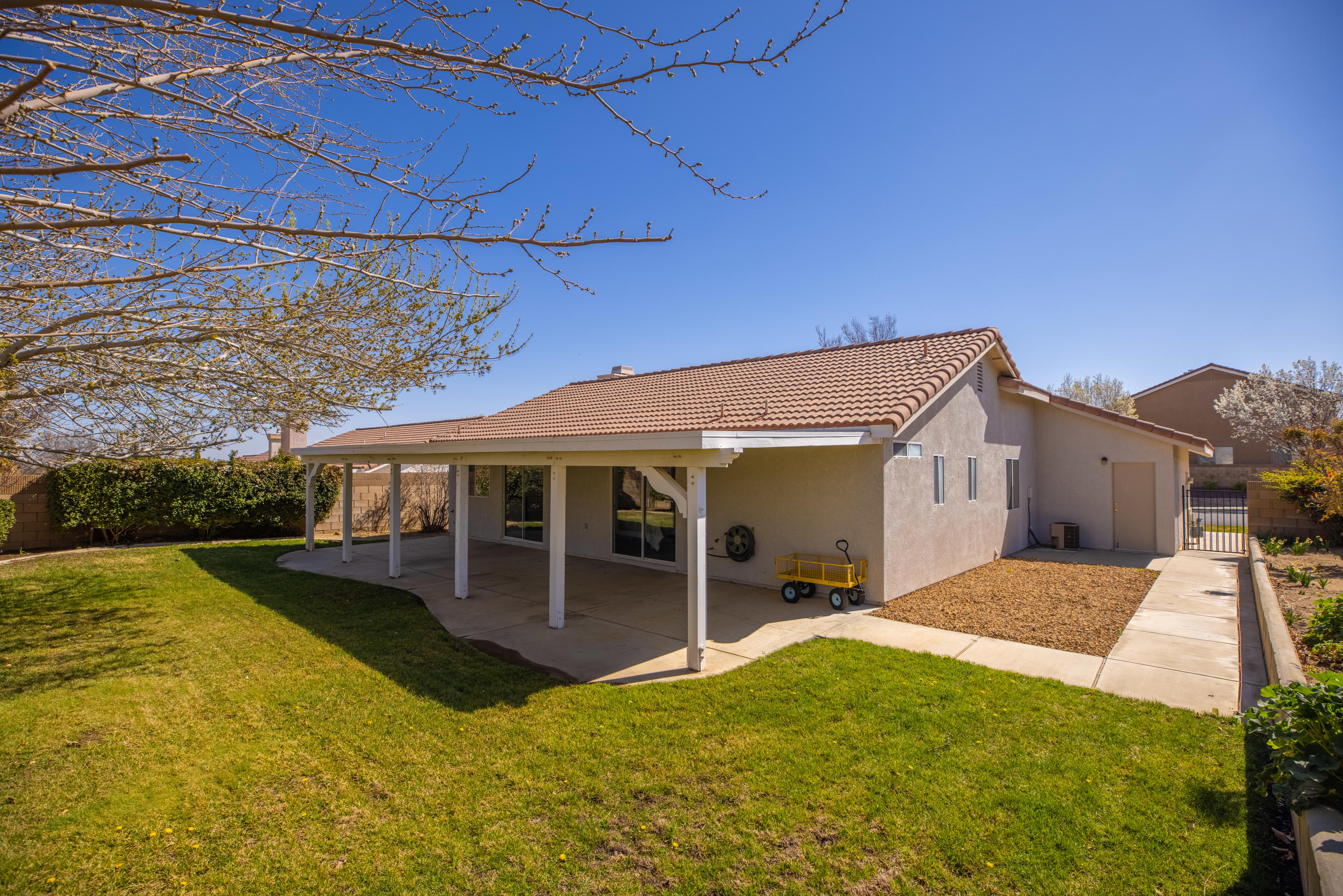 40325 Argyle Lane Palmdale, CA 93551 - Photo 21 of 24 a view of a house with a backyard and porch