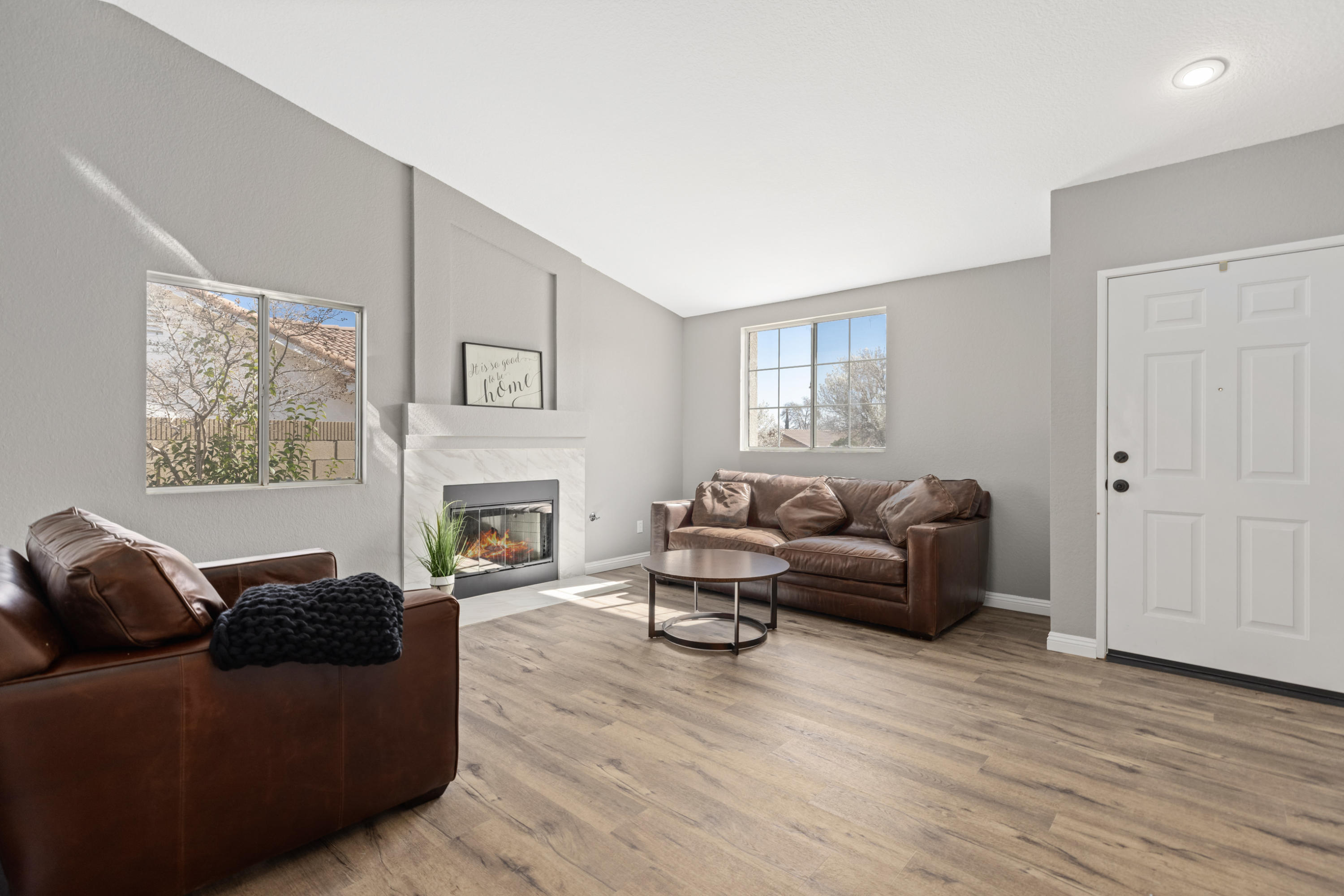 40325 Argyle Lane Palmdale, CA 93551 - Photo 4 of 24 a living room with furniture a fireplace and a wooden floor