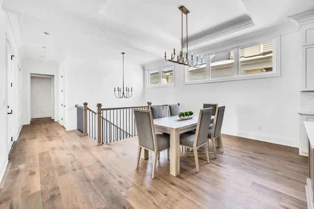 a view of a dining room with furniture wooden floor and chandelier