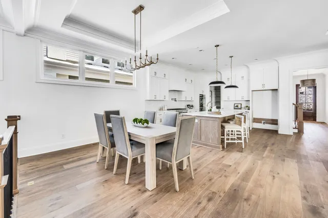 a view of a dining room with furniture wooden floor and chandelier