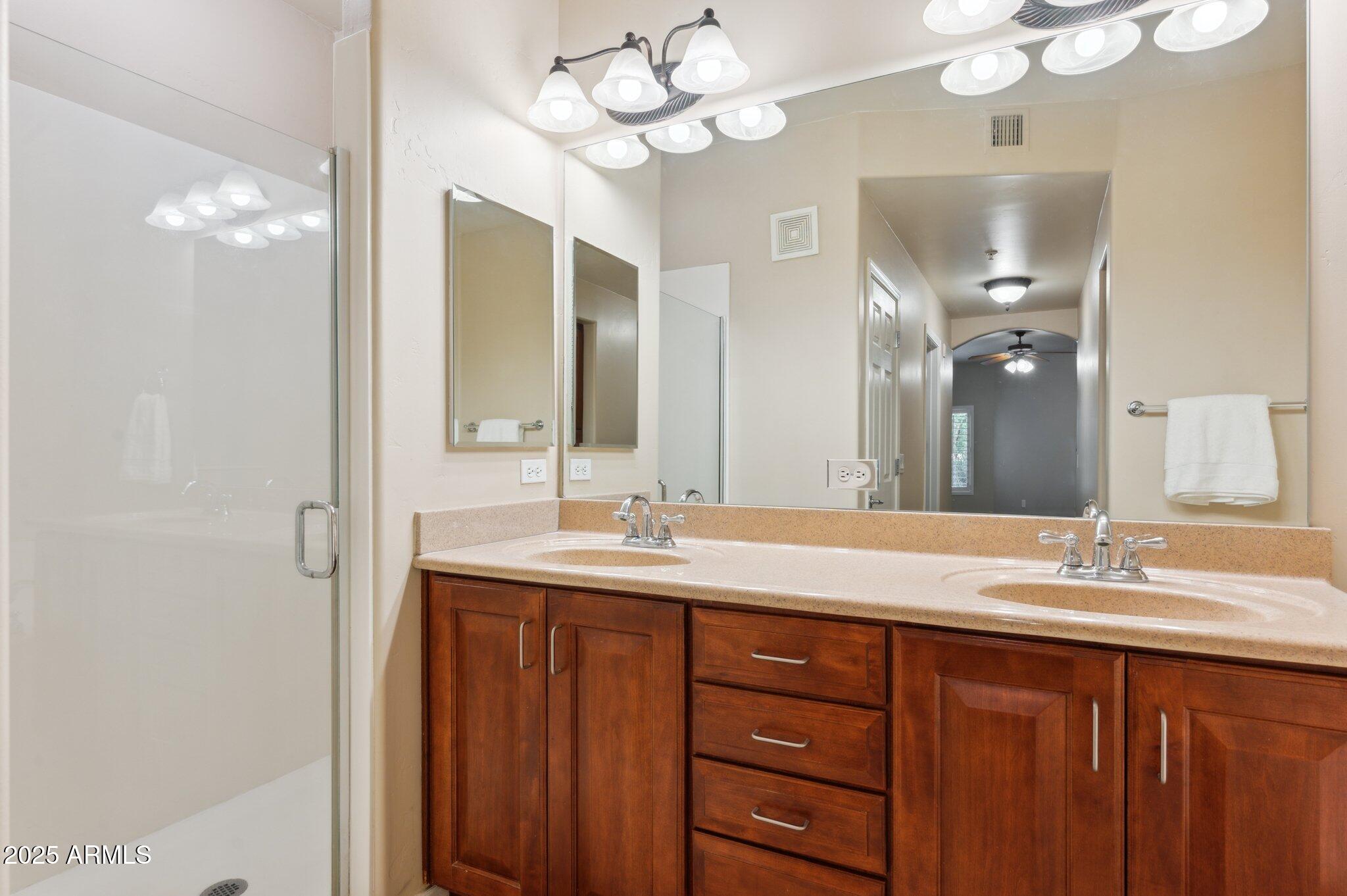 5450 East Deer Valley Drive, Unit 1214 Phoenix, AZ 85054 - Photo 11 of 35 a bathroom with a double vanity sink and a mirror