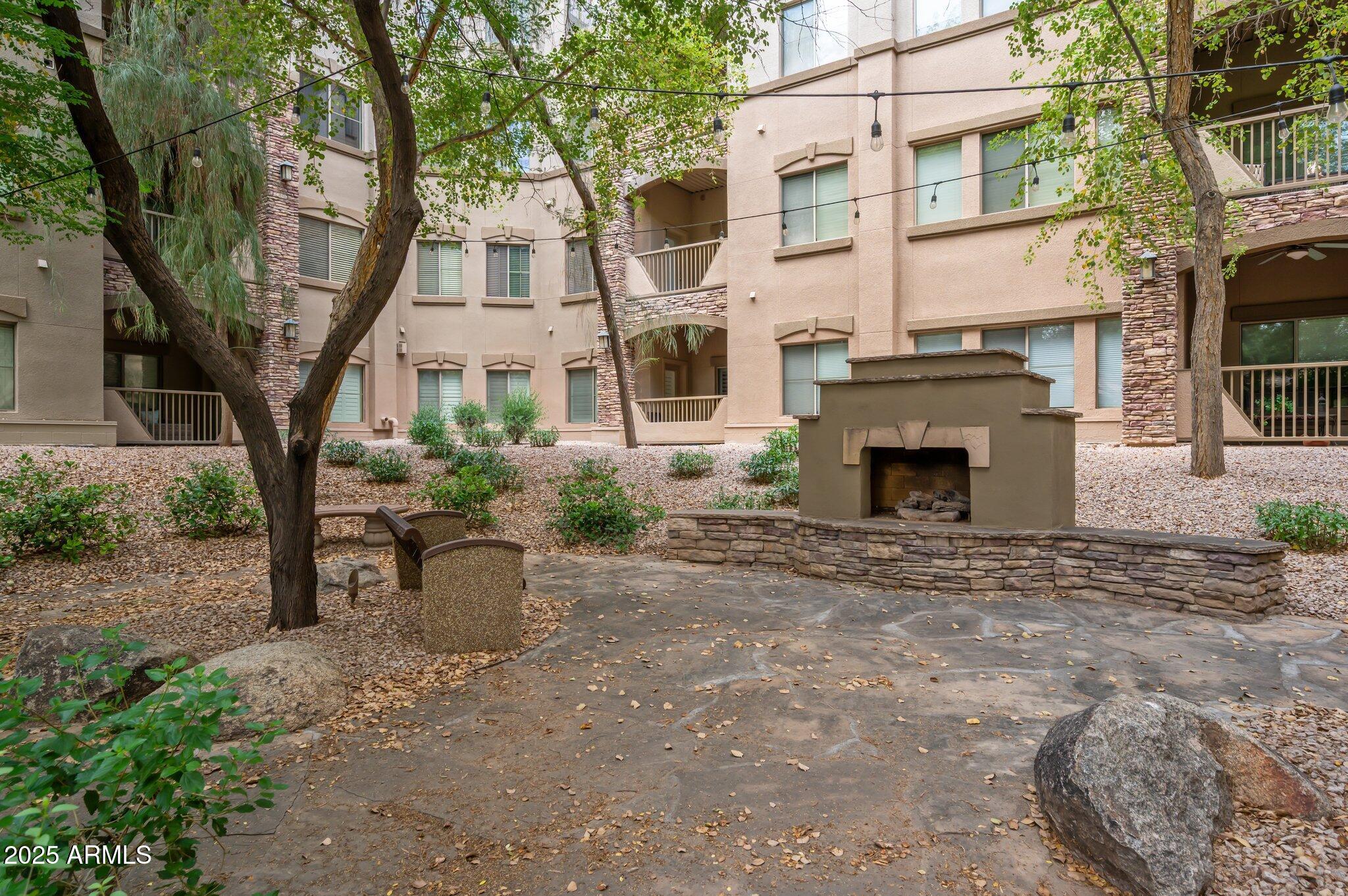 5450 East Deer Valley Drive, Unit 1214 Phoenix, AZ 85054 - Photo 27 of 35 a front view of a house with yard and tree s