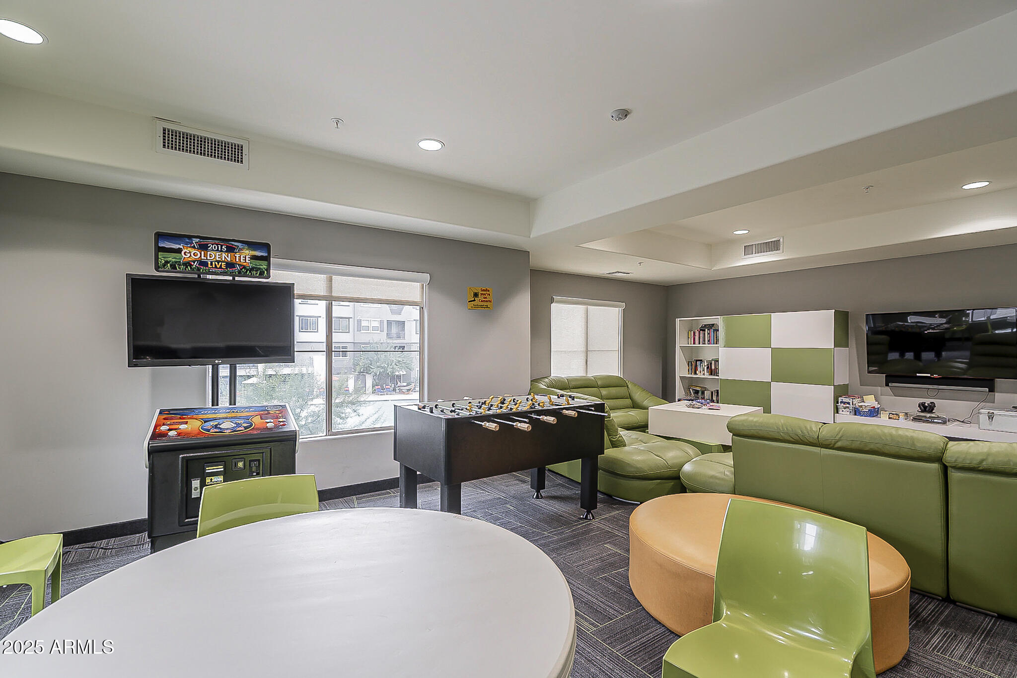 5450 East Deer Valley Drive, Unit 1214 Phoenix, AZ 85054 - Photo 30 of 35 a living room with furniture and a flat screen tv