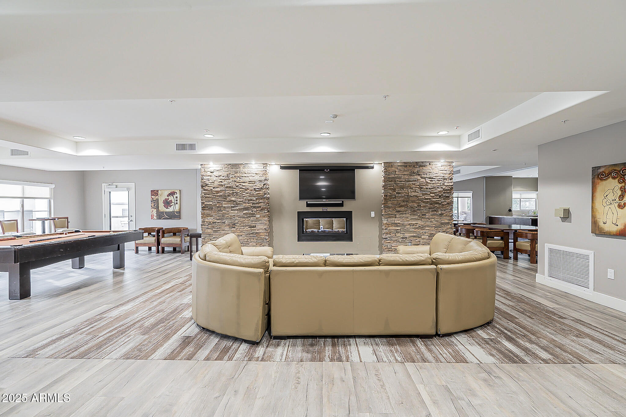 5450 East Deer Valley Drive, Unit 1214 Phoenix, AZ 85054 - Photo 32 of 35 a living room with furniture and a wooden floor