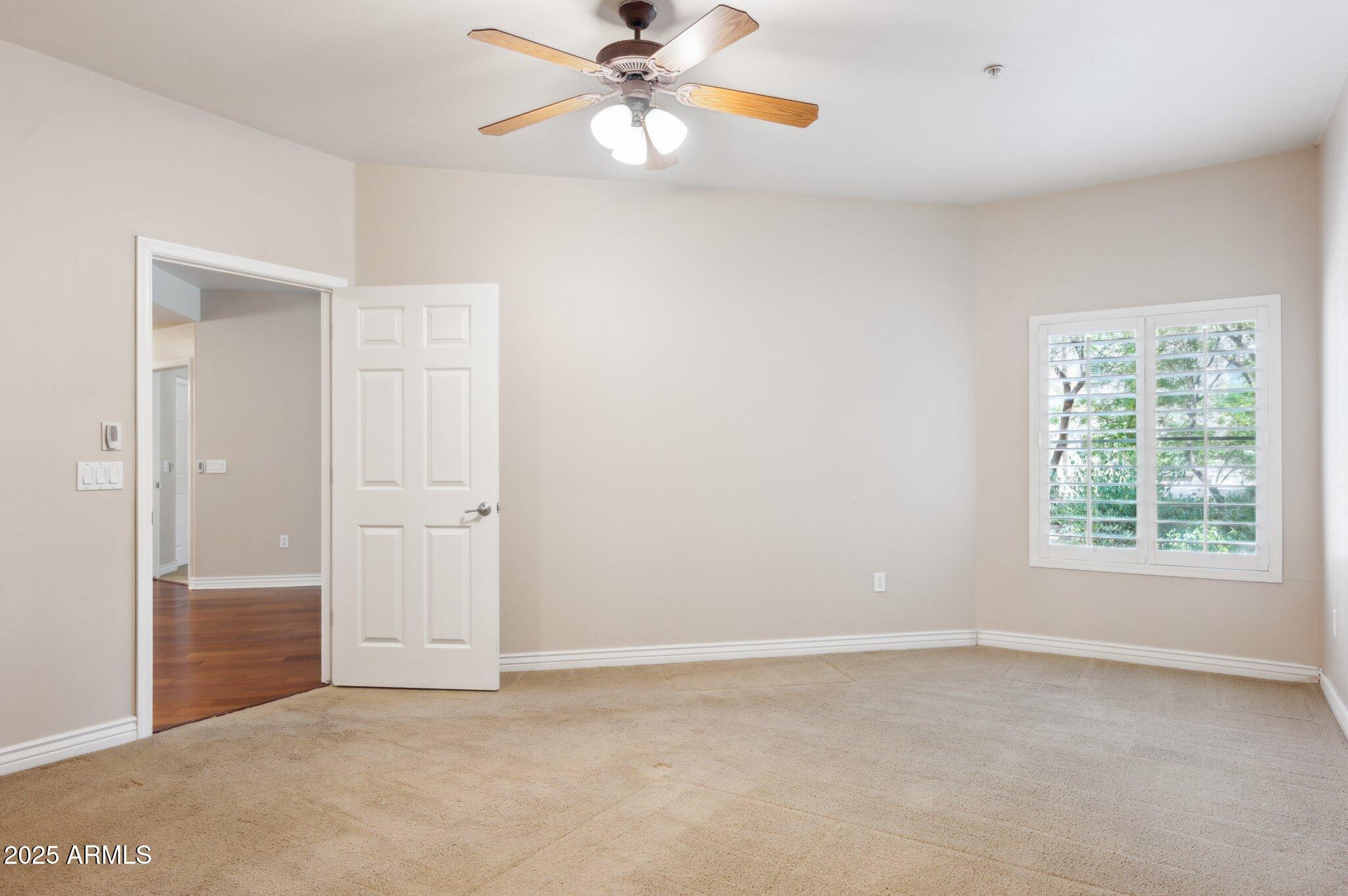 5450 East Deer Valley Drive, Unit 1214 Phoenix, AZ 85054 - Photo 8 of 35 an empty room with windows and fan