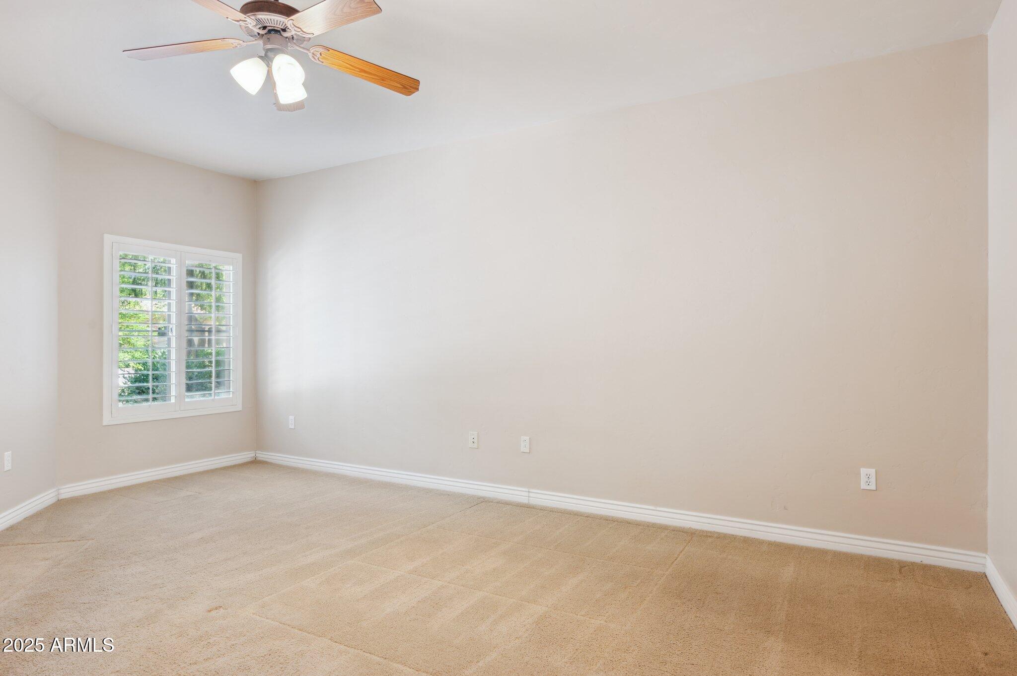 5450 East Deer Valley Drive, Unit 1214 Phoenix, AZ 85054 - Photo 9 of 35 an empty room with windows and fan
