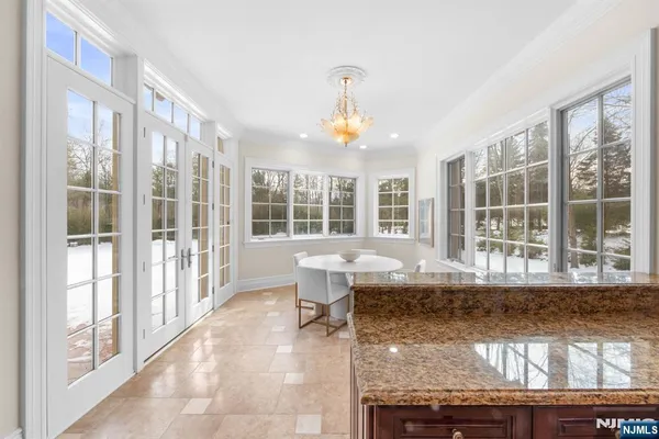 a living room with a large window and chandelier