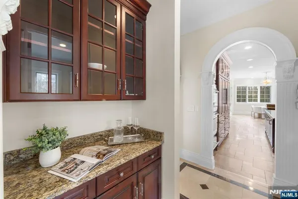a bathroom with a granite countertop sink and mirror