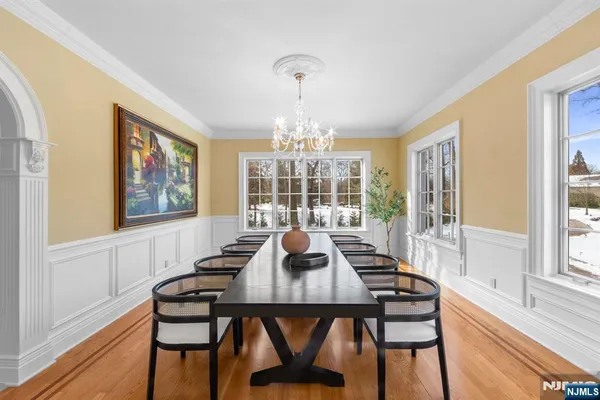a view of a dining room with furniture wooden floor and chandelier