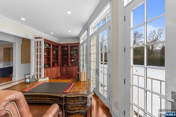 a room with furniture pool table and windows