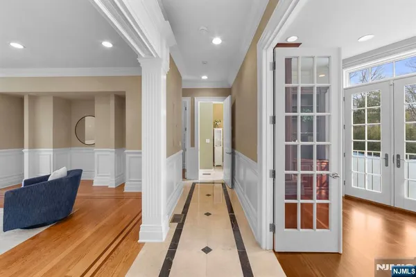 a view of a hallway with wooden floor and staircase