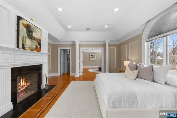 a bedroom with a bed and a fireplace