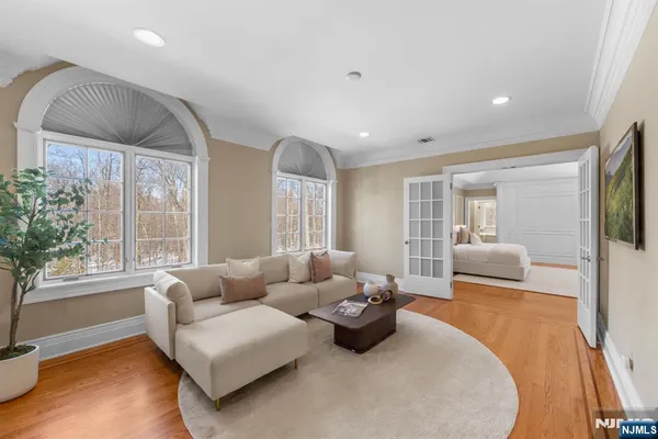 a bedroom with furniture and a large window