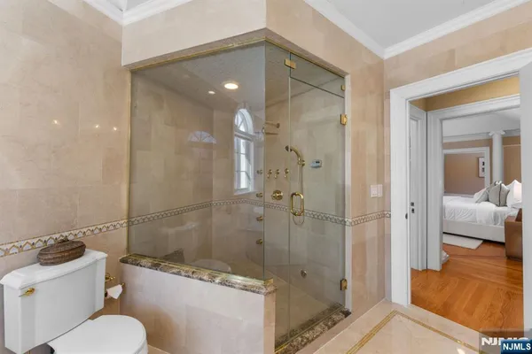 a bathroom with a shower a toilet and a sink