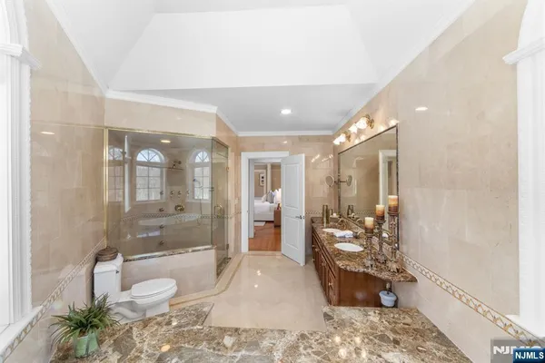 a bathroom with a bathtub shower sink and toilet