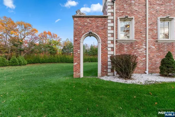 a front view of a house with garden and plants