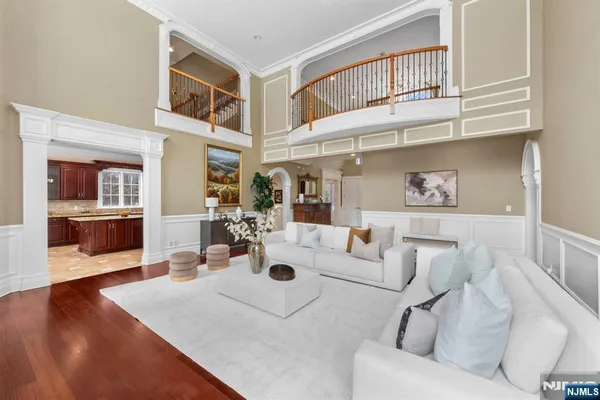 a living room with furniture and a kitchen view