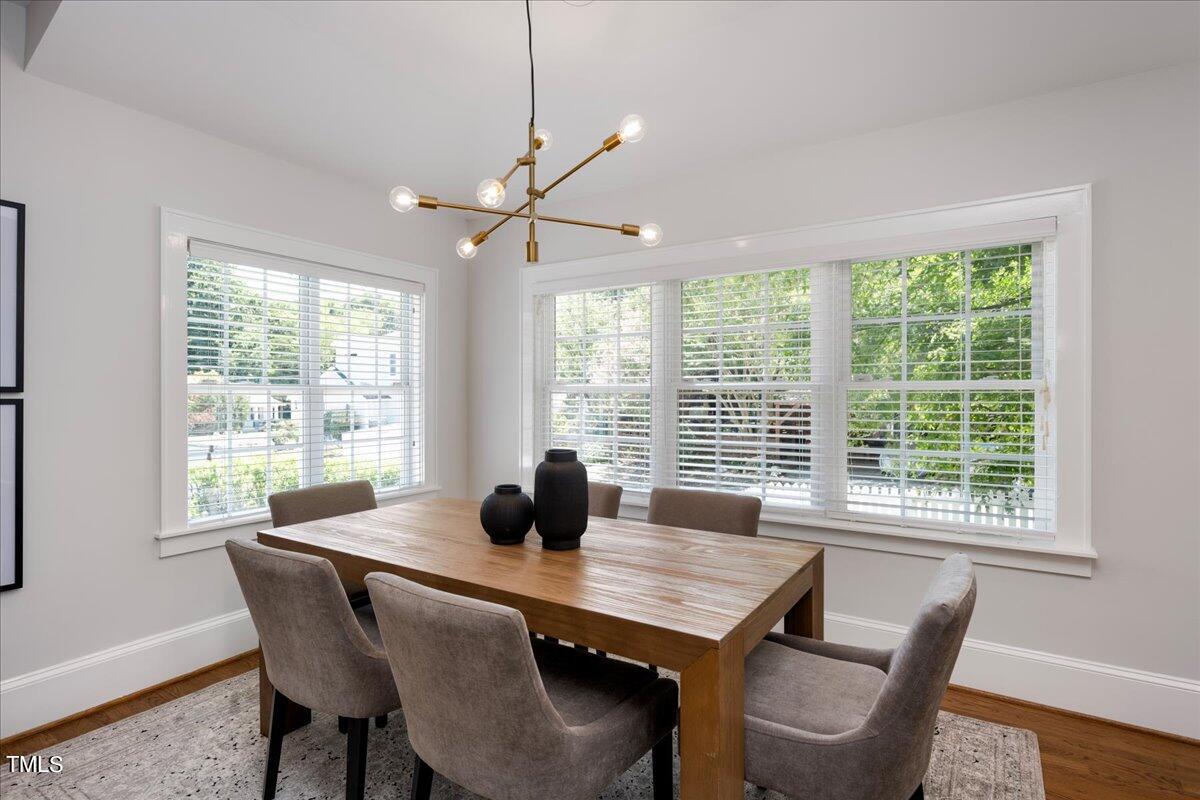 600 Harding Street Raleigh, NC 27604 - Photo 11 of 33 a dining room with furniture a chandelier and wooden floor