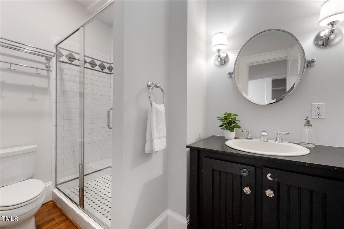 600 Harding Street Raleigh, NC 27604 - Photo 17 of 33 a bathroom with a sink toilet and a mirror