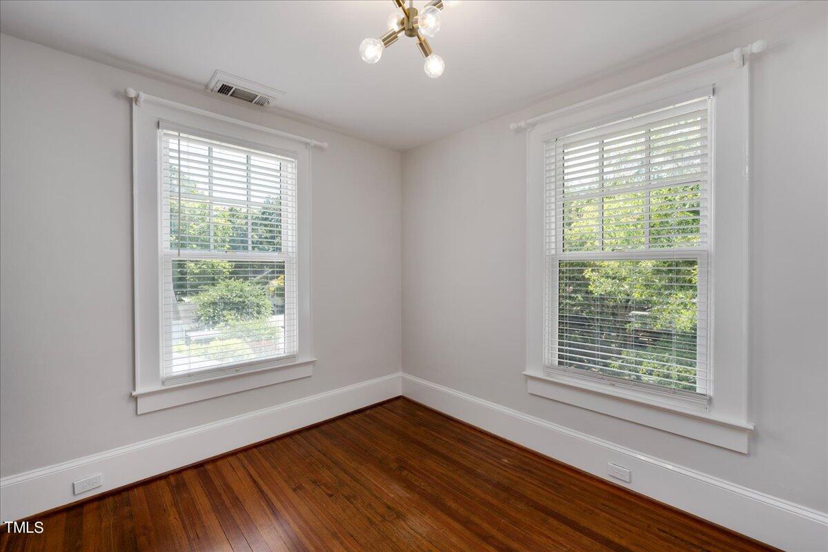 600 Harding Street Raleigh, NC 27604 - Photo 19 of 33 a view of an empty room with wooden floor and a window