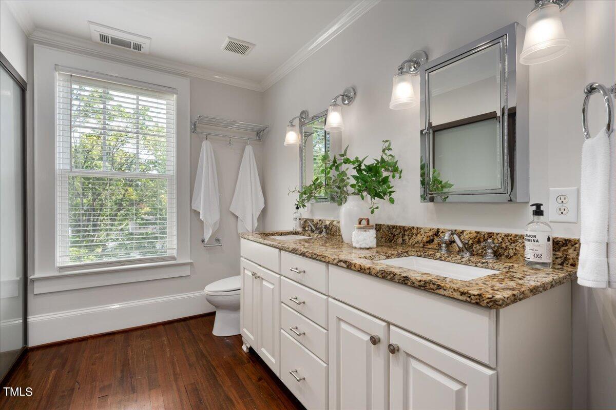 600 Harding Street Raleigh, NC 27604 - Photo 25 of 33 a bathroom with a granite countertop sink mirror vanity and toilet