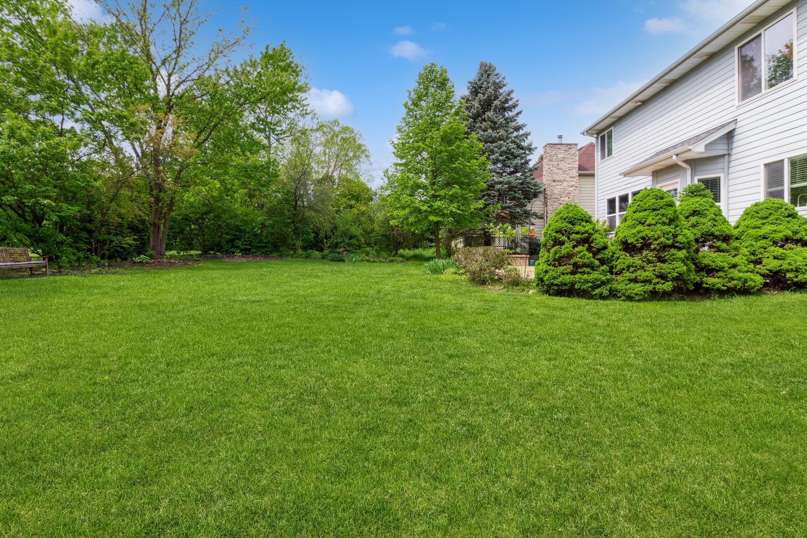 705 Queens Gate Circle Sugar Grove, IL 60554 - Photo 25 of 25 a view of a garden with a house in the background
