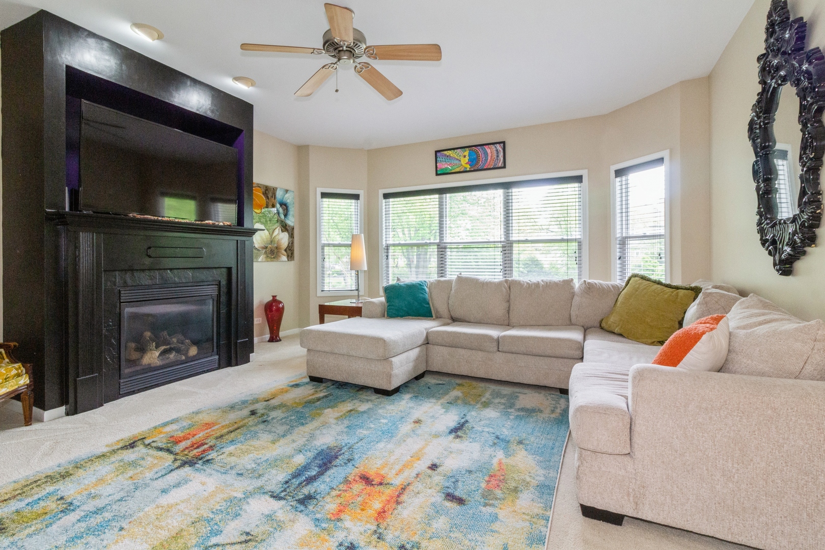 705 Queens Gate Circle Sugar Grove, IL 60554 - Photo 10 of 25 a living room with furniture a flat screen tv and a fireplace