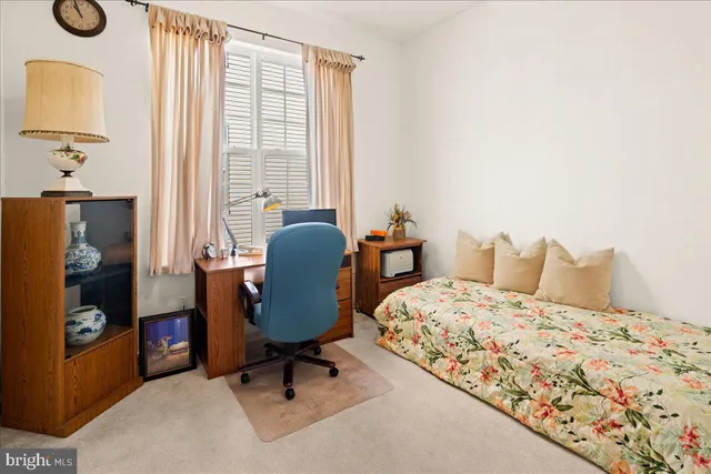 a spacious bedroom with a bed and a window