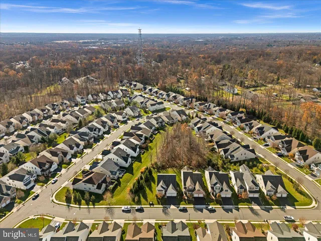 a view of a tennis ground with large trees