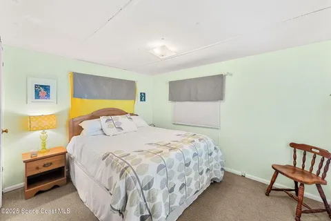 a bedroom with a bed and dresser