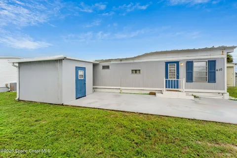 a view of a backyard with a garden and yard