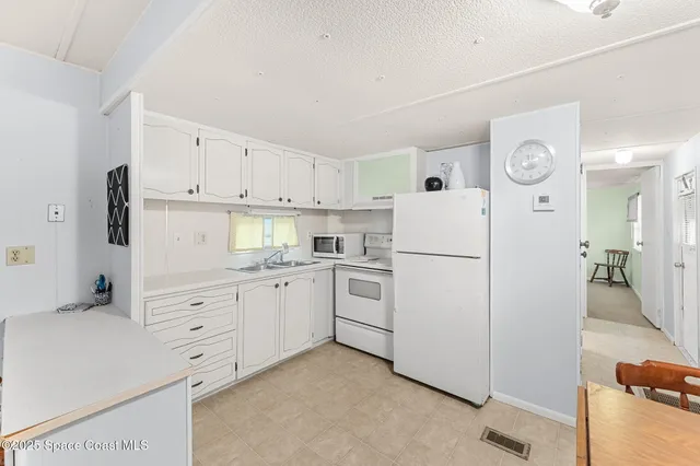 a kitchen with a stove a refrigerator and a dining table
