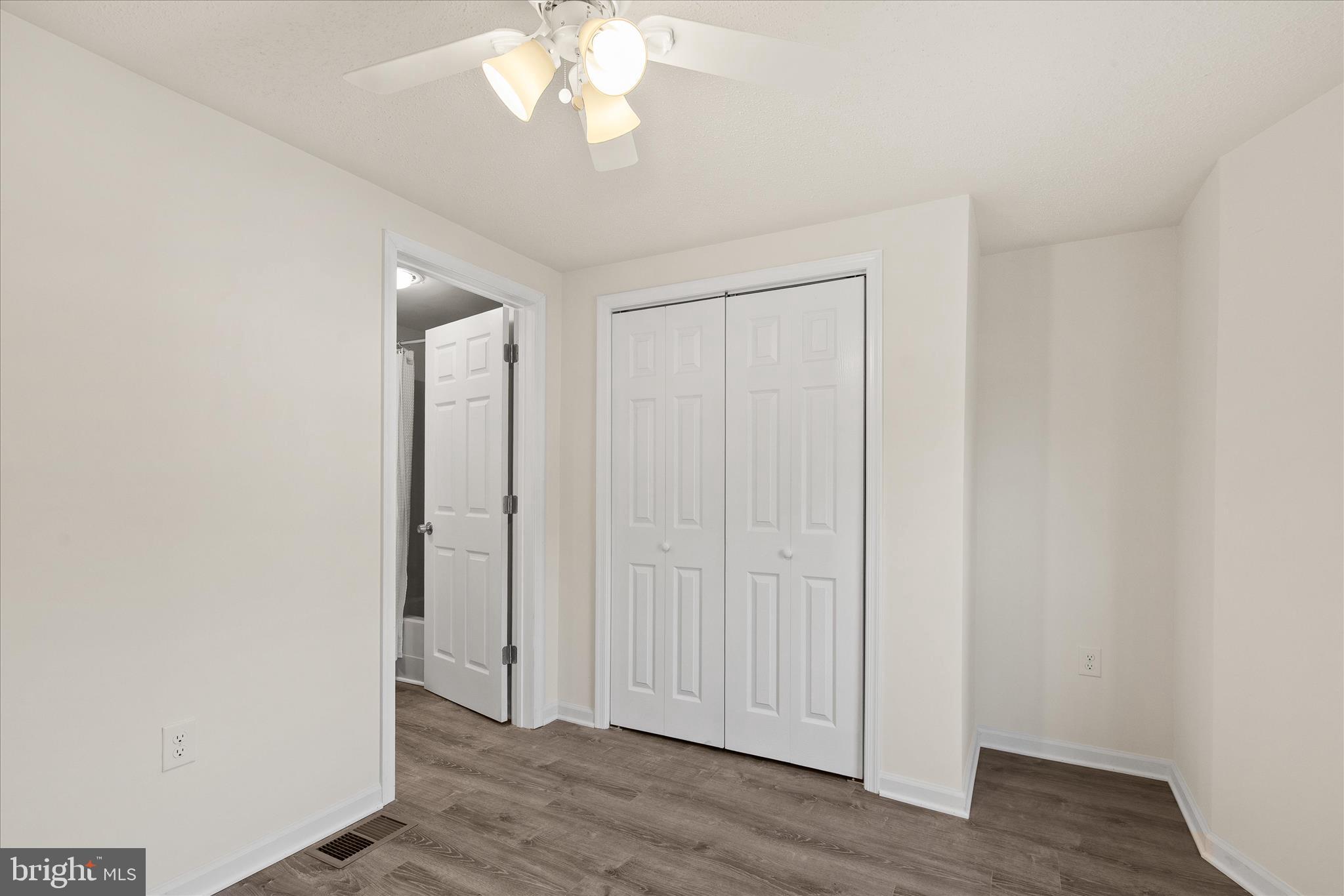 26465 Mason Webster Road Princess Anne, MD 21853 - Photo 29 of 56 an empty room with wooden floor and hallway