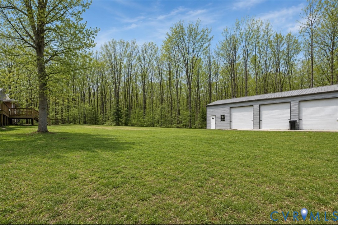 239 Jennings Road Cartersville, VA 23027 - Photo 6 of 26 Expansive green lawn with a large multi-bay garage