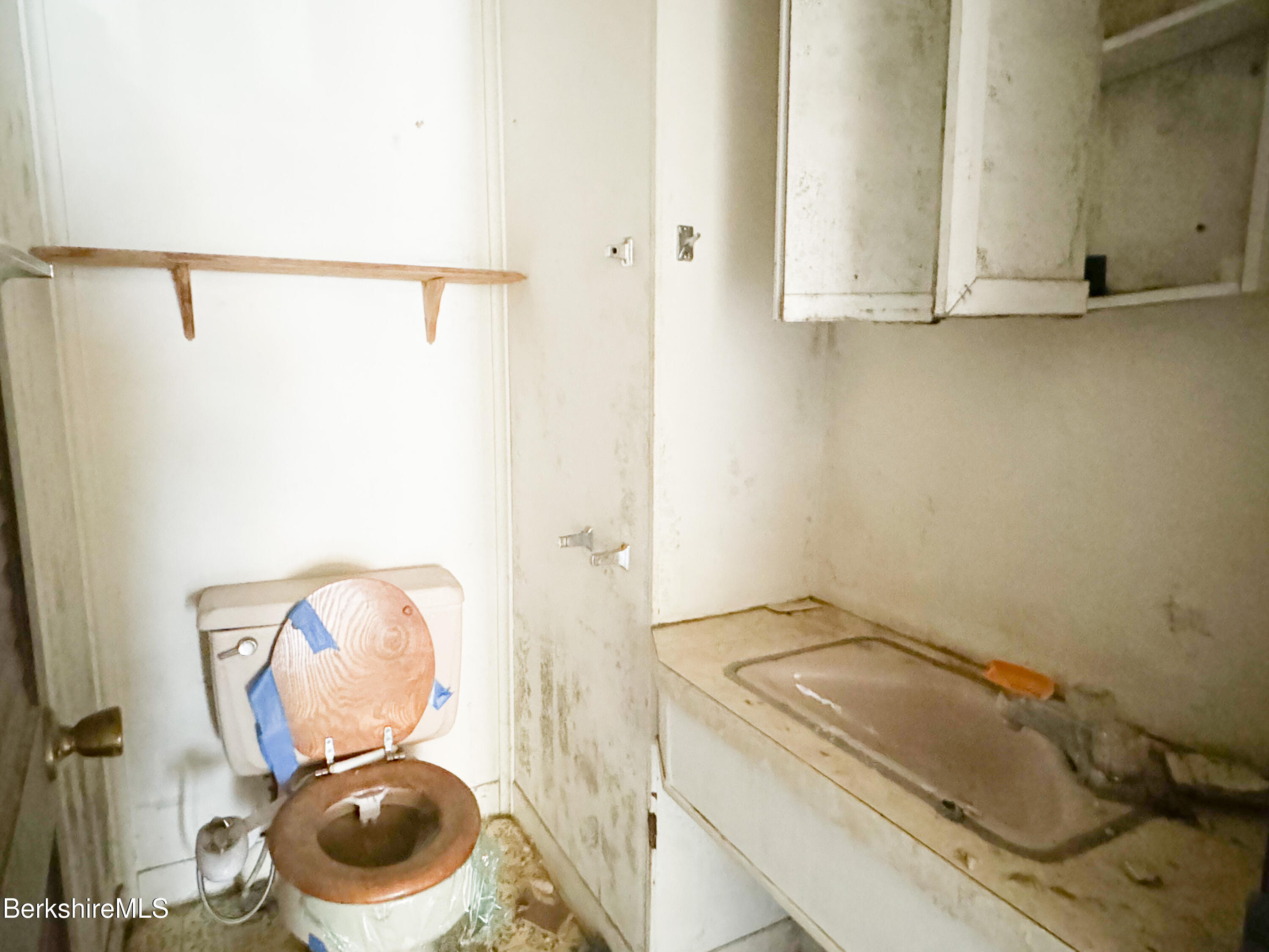 223 Elm Street Holyoke, MA 01040 - Photo 12 of 30 a bathroom with a toilet and a sink