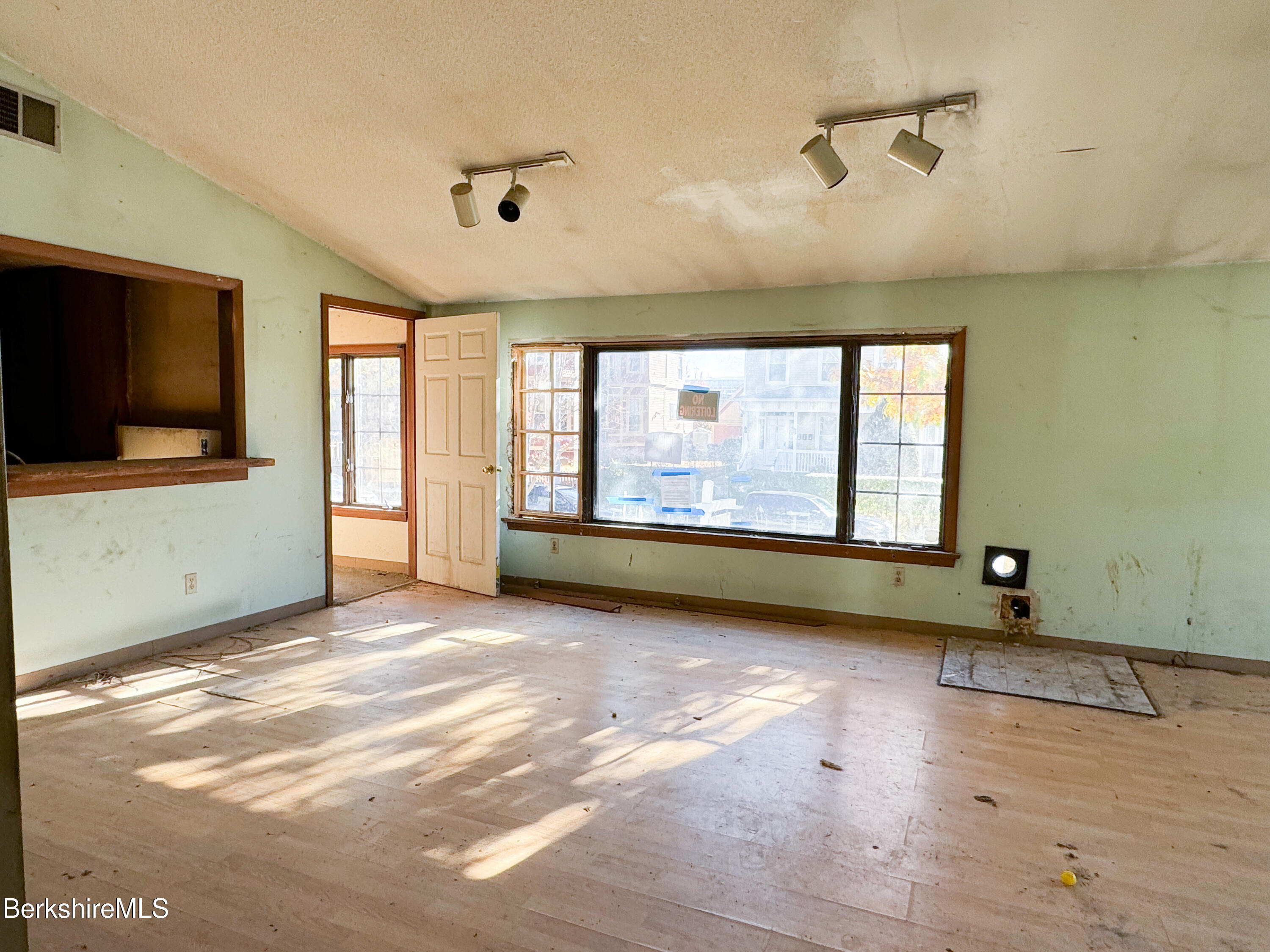 223 Elm Street Holyoke, MA 01040 - Photo 9 of 30 a view of an empty room with a window and wooden floor