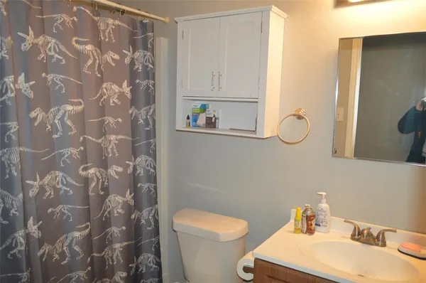 a white toilet sitting next to a bathroom sink