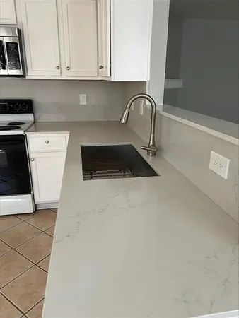 a kitchen with a sink and a stove top oven